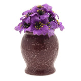 Nightmare Before Christmas Deadly Nightshade Planter in Purple, a speckled plum urn-shaped pot topped with artificial violet flowers, shown on a plain white background.