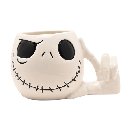 Jack Skellington shaped ceramic mug in glossy white with black eyes, arched brow and stitched grin, featuring a bony skeleton hand handle, on a plain background.