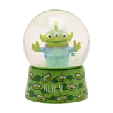 Toy Story Alien glitter plastic snow globe with three-eyed green alien, arms outstretched, inside a clear globe with green glitter on a green alien-print base.