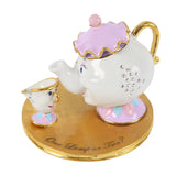 White lilac ruffled-lid teapot trinket box with gold handle and jewels, hinged lid, teacup on gold base reading One Lump or Two, on white background.