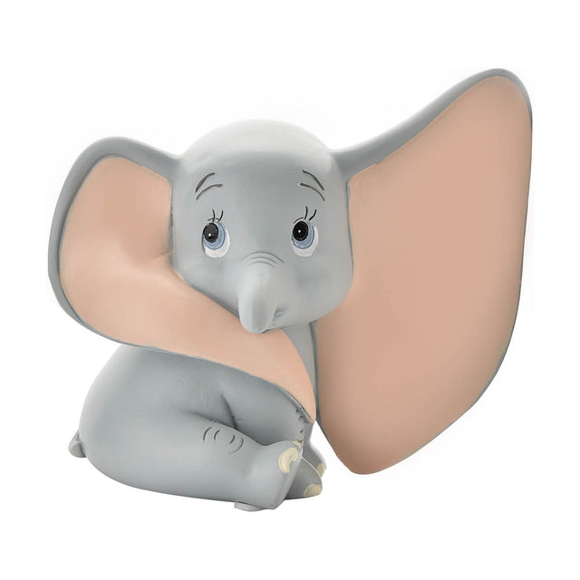 Sitting Dumbo Elephant resin money box with coin slot, grey matt finish and pale pink ear detail, big blue eyes, on a plain white background.