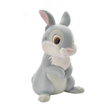 Thumper Rabbit money box figurine in grey resin, seated with paws folded, white chest and cheeks, pink ears and nose, rear coin slot, on a plain white background.