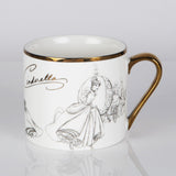 White porcelain mug with gold rim and handle, featuring grey pencil-style sketches of Cinderella in her gown and coach, with her name in gold script, on a plain background.