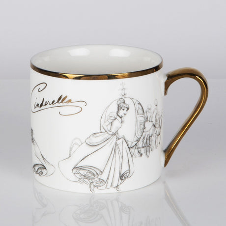 White porcelain mug with gold rim and handle, featuring grey pencil-style sketches of Cinderella in her gown and coach, with her name in gold script, on a plain background.