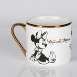 White gloss porcelain mug with gold rim and handle, featuring a sketch-style Minnie Mouse illustration and "Minnie Mouse" in gold script, shown against a plain light background.