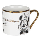 White gloss porcelain mug with gold rim and handle, featuring two pencil-sketch Minnie Mouse illustrations and gold "Minnie Mouse" script, shown on a plain white background.
