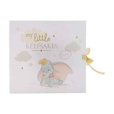 White square paperwrap keepsake box featuring Dumbo among pastel clouds and gold stars, with "my little KEEPSAKES" lettering and a gold ribbon closure.