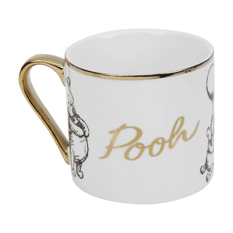 White porcelain Pooh mug with gold rim and handle, featuring black sketch-style illustrations and "Pooh" in gold script, shown on a plain white background.