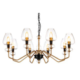 Introducing the Armand 8 Light Chandelier, featuring a sleek and modern aesthetic with eight bulb fixtures, each elegantly enclosed in a clear glass shade. This sophisticated design showcases a gold structure accented by charcoal black paint, complemented by angular arms stemming from a central column. The chandelier is suspended gracefully by a black chain, emphasizing its elegant aged brass plated finish.