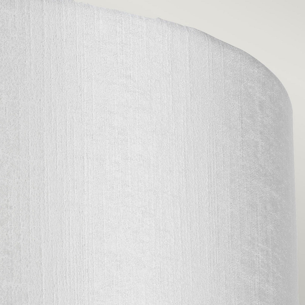 Close-up of the Cooper Medium Curved Wall Light in aged brass, featuring a minimalist white textured surface with rounded edges against a light grey background.