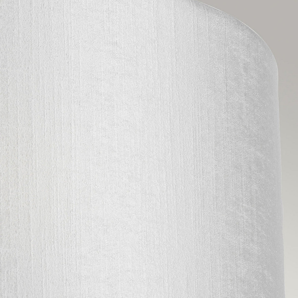 Close-up of the Cooper Medium Curved Wall Light with a polished chrome finish, featuring a textured white lampshade that has a soft, smooth appearance and casts a subtle shadow to the left. Situated in contemporary interiors with a neutral gray background that emphasizes the understated elegance of the lampshade's fabric.