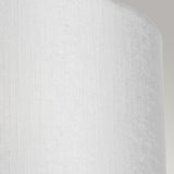 Close-up of the Cooper Medium Curved Wall Light with a polished chrome finish, featuring a textured white lampshade that has a soft, smooth appearance and casts a subtle shadow to the left. Situated in contemporary interiors with a neutral gray background that emphasizes the understated elegance of the lampshade's fabric.