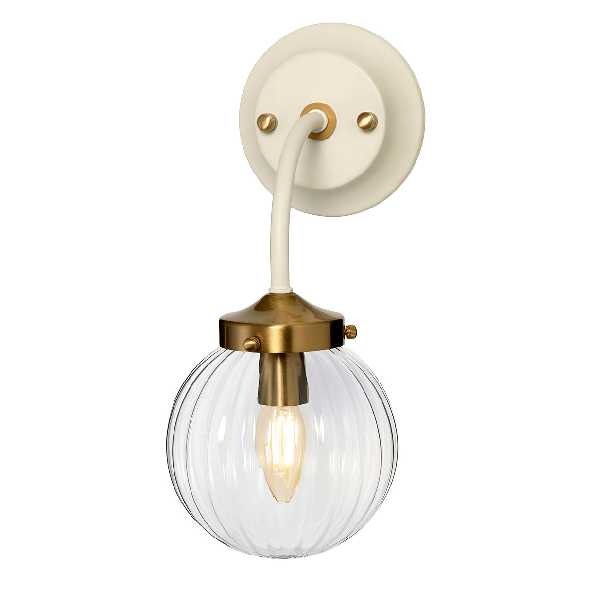 The Cosmos Wall Light - Cream Painted & Aged Brass is a wall-mounted fixture with a cream and brass base. It features a clear ribbed glass globe that houses a visible bulb, blending ambient lighting with retro design. This piece seamlessly combines modern and vintage elements, making it perfect for indoor décor.