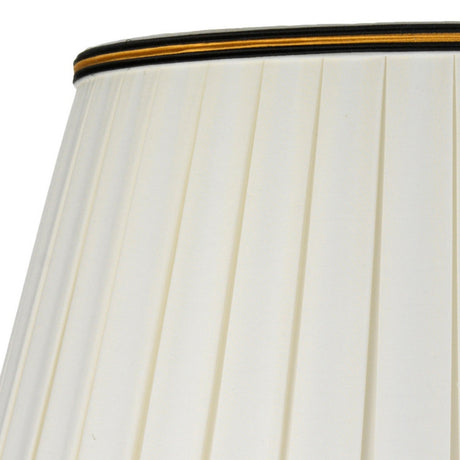 Close-up of the upper section of a tall empire shade showcasing a white pleated design with decorative trim at the top. The trim includes an elegant black and gold stripe, echoing the intricate detailing found on the Dian Table Lamp With Tall Empire Shade - Silver & Gold.