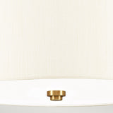 Close-up of the textured ivory shade on the Fletcher 14" Flush - Aged Brass with Ivory Shade, showcasing a subtle brass detail at the center bottom. The image emphasizes the fabric and the lampshade's minimalist flush mount style.