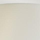 Close-up view of a simple, light beige lampshade with a textured surface. The top edge is smoothly rounded, forming a gentle arc against a plain white background, reminiscent of the elegant design found in the Harbin Gourd Table Lamp With Tall Empire Shade in Duck Egg Blue.