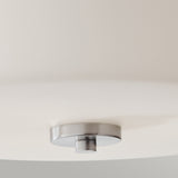 Close-up of the Kincaid 3 Light Flush - Polished Chrome, showcasing its opal-etched glass and polished chrome base. The design boasts clean lines and a central metal accent, embodying a minimalist aesthetic ideal for those desiring a close-to-ceiling look.