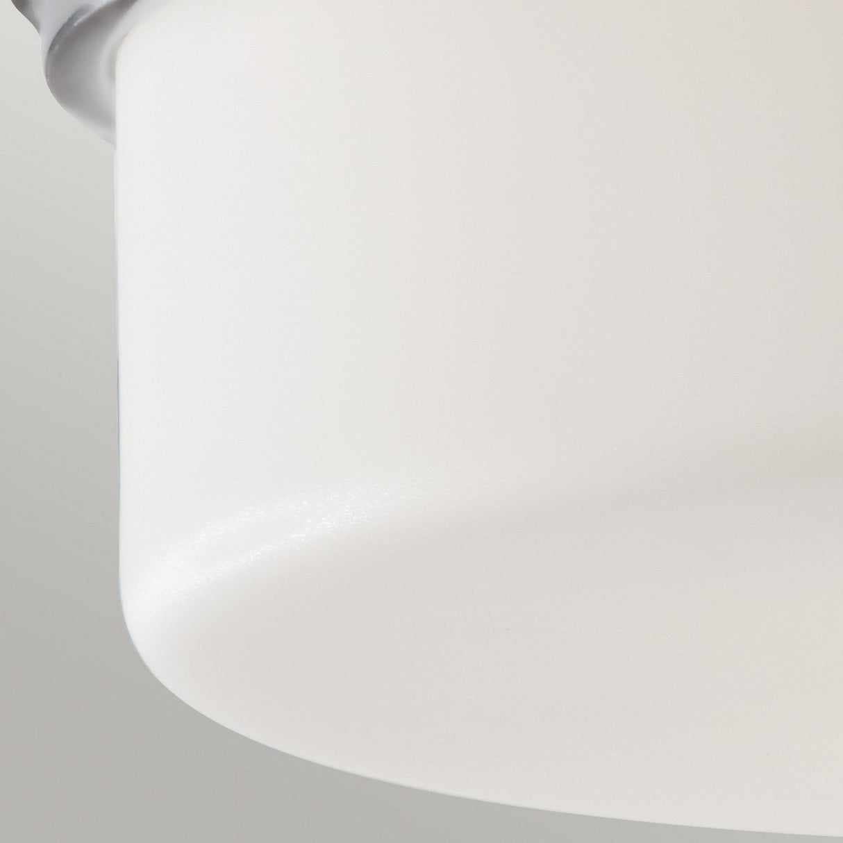 Close-up of a smooth, opal-etched glass lampshade from the Kincaid 3 Light Flush - Polished Chrome against a light gray background. The matte surface complements the polished chrome fixtures, whose top edge is slightly visible, accentuating its rounded shape.
