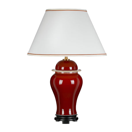 The Oxblood Temple Jar Table Lamp With Tall Empire Shade - Oxblood showcases oriental elegance with its curved, glossy red ceramic base that commands attention. It is complemented by a white, tapered lampshade with a gold-trimmed edge, standing gracefully on a small black platform.