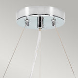 A contemporary ceiling-mounted fixture featuring a sleek, polished chrome design, reminiscent of the Pearce 18" Pendant Light. Three thin cords support a central nozzle that emits a steady stream of water, evoking the elegance of an ivory-shaded pendant light against a neutral backdrop.