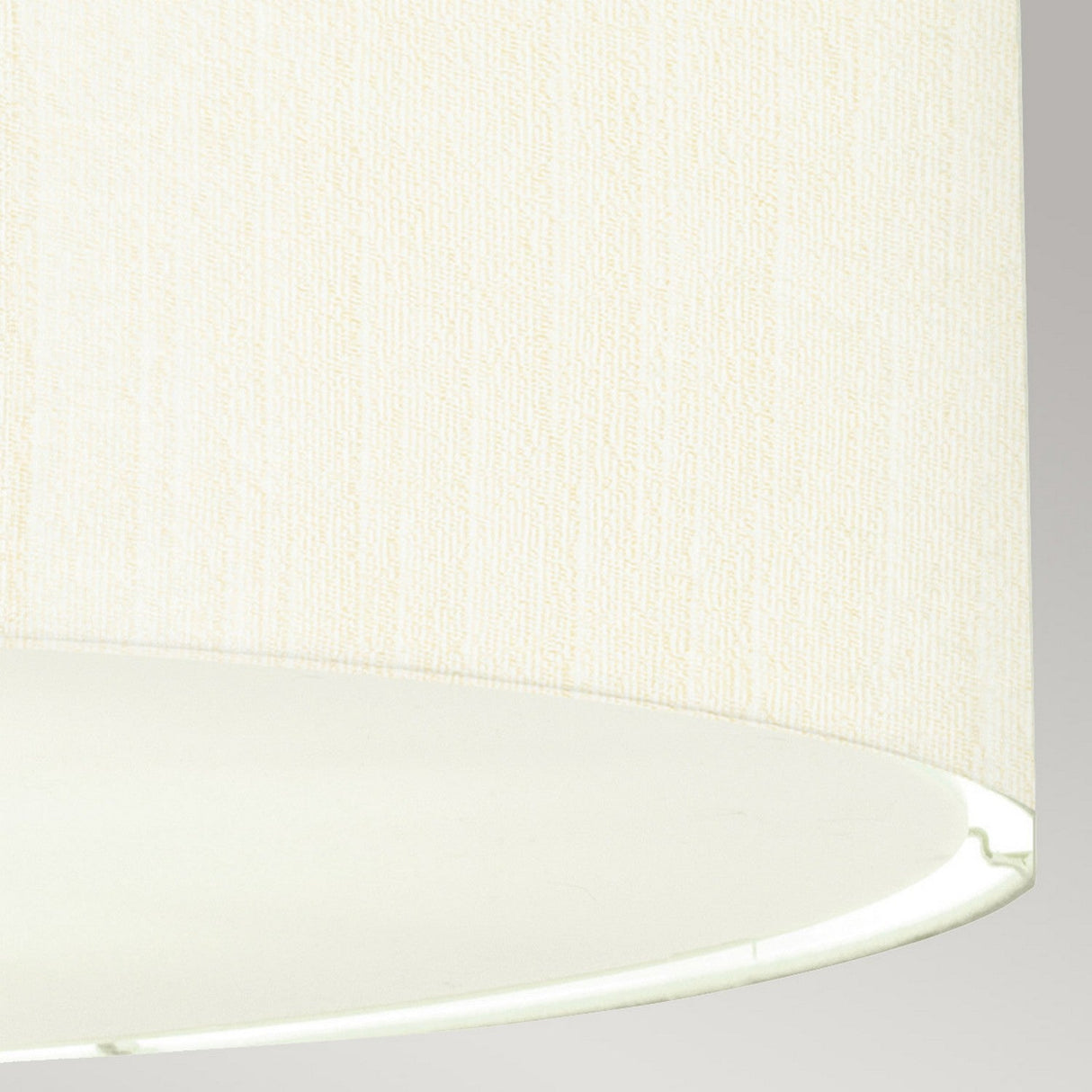 A close-up of the Pearce 22" Pendant Light showcases its textured ivory shade set against a light gray background, highlighting the lower edge and inner portion. Ideal for modern interiors, its refined elegance is beautifully enhanced by polished chrome accents.
