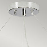 Close-up of the Pearce 30" Pendant Light - Polished Chrome, Ivory Shade, showcasing a modern lighting design with a round metallic base in polished chrome. Sleek cables elegantly extend from the base, supporting the structure against a neutral background.
