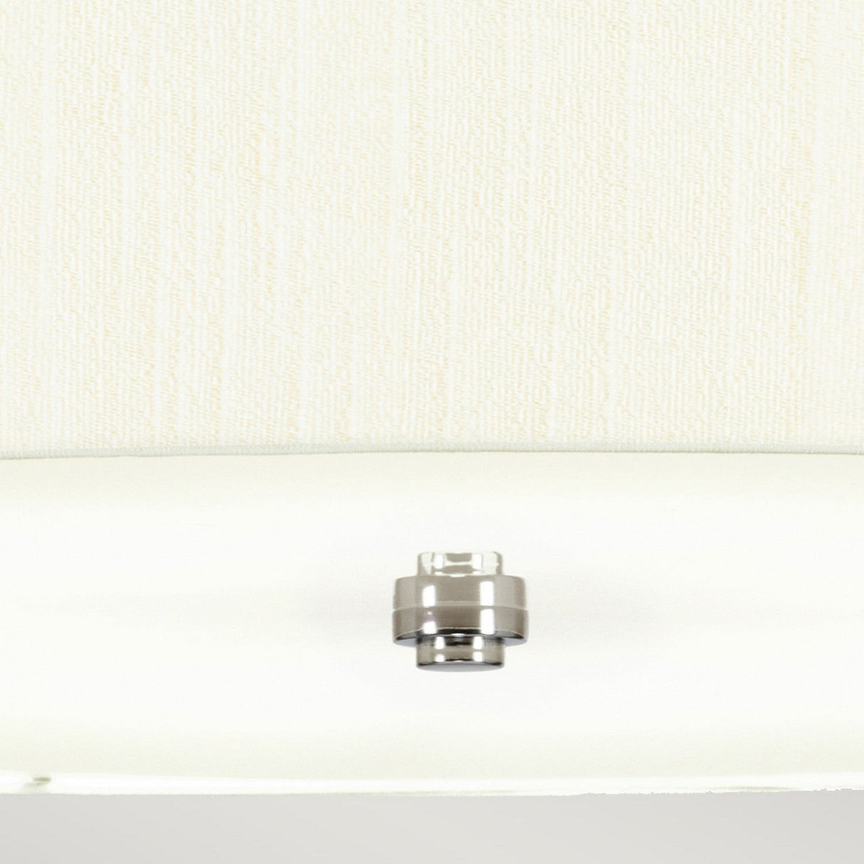 A metallic knob or fixture, echoing the sleek design of the Pearce 30" Pendant Light - Polished Chrome, Ivory Shade, rests centered on a light-colored, textured wall. Its polished chrome surface is smooth and reflective, contrasting sharply with the vertical lines of the modern wallpaper.