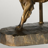 A close-up of a bronze sculpture highlights the muscular hind leg and torso of a horse, showcasing an exquisite bronze patina. The piece is set on a textured, rectangular bronze base, similar to the fine art details found in the Rufus Table Lamp With Oval Shade - Bronze Patina.