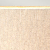 Close-up of the Spirit Table Lamp With Oval Shade in bronze patina, showcasing its fine, textured fabric. When illuminated from within, it emits a warm glow that enhances the overall ambiance. The light background complements its warmth, making it ideal for equestrian enthusiasts seeking a cozy atmosphere.