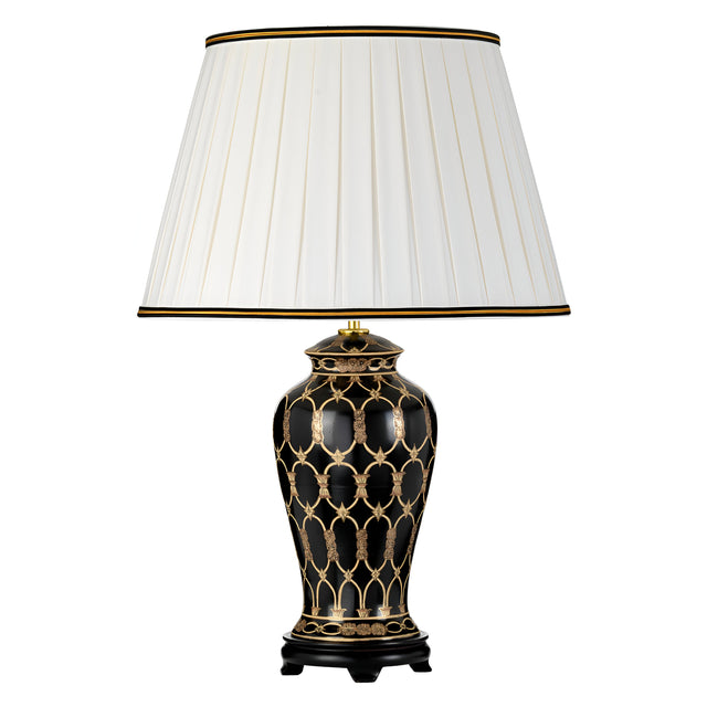 The Taipei Table Lamp with Tall Empire Shade is a decorative piece featuring a white pleated lampshade atop an oriental ceramic vase-like base adorned with gold geometric patterns. This black and gold lighting accent stands gracefully on a small black platform, bringing intricate detailing to any space.