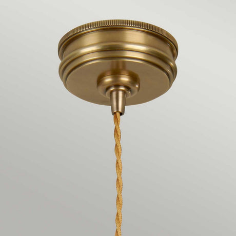 The Douille 1 Light Pendant in aged brass showcases a twisted braided cord, elegantly suspended against a plain background.