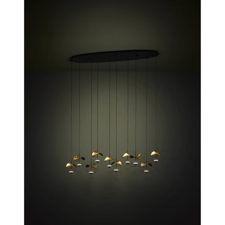 Dracera 10 Light Linear Pendant in black, oval steel ceiling canopy with ten cords ending in leaf-shaped black and gold shades, shown illuminated against a dark background.
