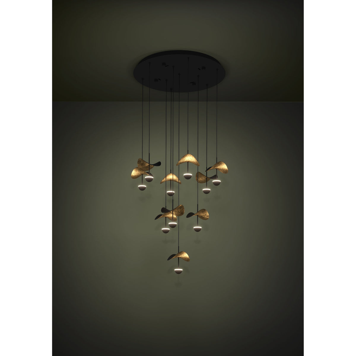 Dracera 10 Light Pendant in black, a cascading ceiling fixture with slim drops holding curved leaf-shaped shades in black and gold above small illuminated domes.