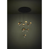 Dracera 10 Light Pendant in black, a cascading ceiling fixture with slim drops holding curved leaf-shaped shades in black and gold above small illuminated domes.