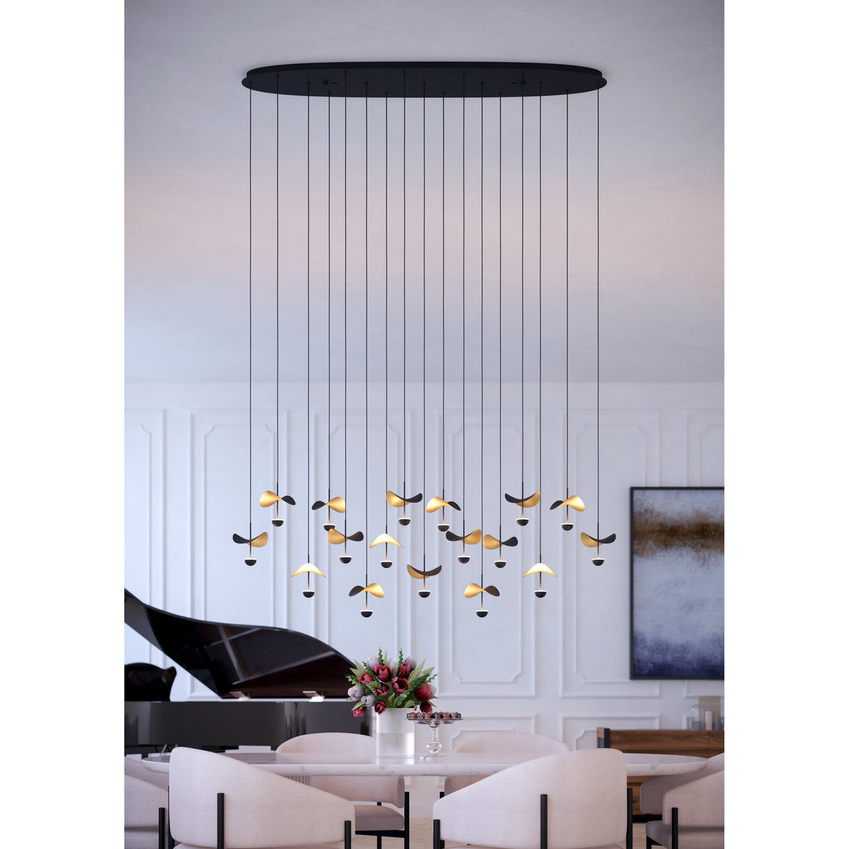 Dracera 17 Light Linear Pendant Light in black steel, oval canopy with hanging cords ending in leaf-shaped black and gold shades, shown above a dining table.