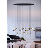 Dracera 17 Light Linear Pendant Light in black steel, oval canopy with hanging cords ending in leaf-shaped black and gold shades, shown above a dining table.