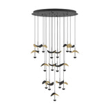 Dracera 17 Light Pendant in black with round steel canopy, seventeen staggered cords, dome heads, and curved leaf-shaped shades in gold and black, on a white background.