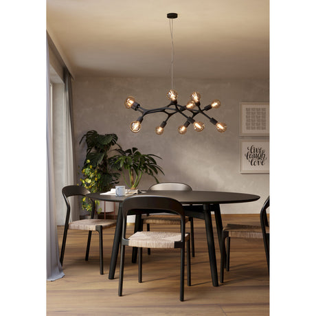Dramenne 12 Light Pendant in black steel with branching curved arms and exposed bulbs, hung above a dark dining table in a neutral-toned room.