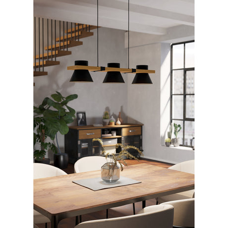 Drasvenne Linear Pendant Light with three black conical shades on a wood-toned bar, suspended over a wooden dining table in a living space.
