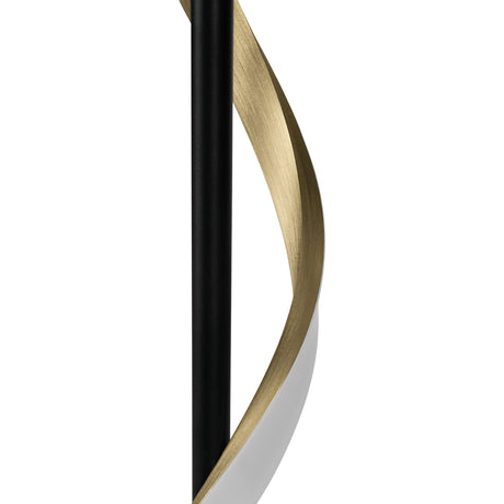 Close-up of the Drosmine LED table lamp, showing a slim black pole with a brushed brass ribbon spiralling around it, white plastic inner face, on a plain background.