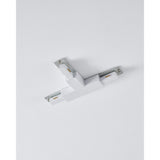 Easyt Track T Connector in white plastic, a three-arm T-shaped joiner with silver mounting plates, screws and brass contact tabs, shown mounted on a plain ceiling.