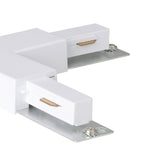 Close-up of the Easyt Track T Connector in white plastic, showing two track arms with silver mounting plates, screws, and brass contact tabs, on a plain white background.