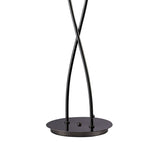 A detailed view of the Eclipse 2 Light Floor Lamp - Black Chrome shows two black metal rods crossing on a round, flat base—perfect for adding contemporary style to any room.