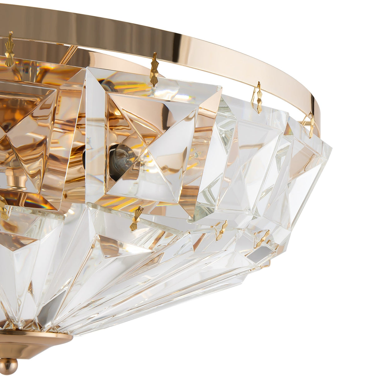 Close-up of the Facet 6 Light Flush, showcasing a luxurious design with a gold frame and clear geometric crystal accents. This elegant and modern chandelier beautifully reflects light, emphasizing its intricate crystal details.