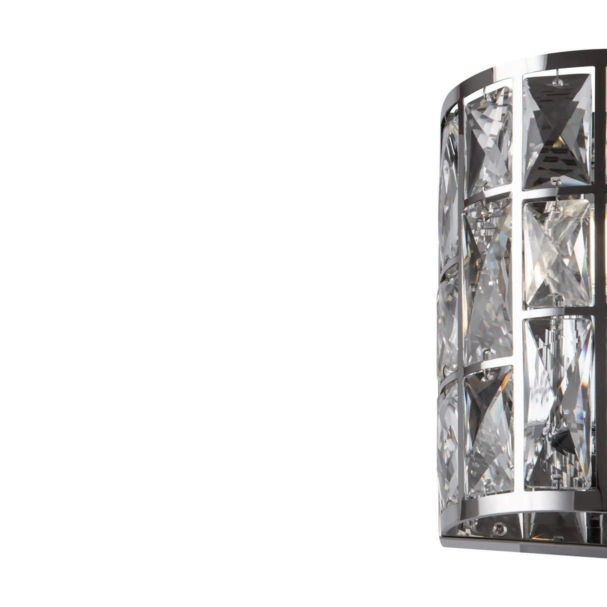 The Gelid Wall Light, featuring a chrome frame and geometric crystal-like panels, illuminates its clear, faceted surfaces to create a sophisticated and elegant appearance against a plain white background.