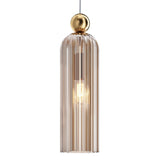 The Antic Pendant Light features a gold cognac ribbed glass shade with a warm glowing bulb inside, hanging from a wire. A gold metallic accent at the top adds vintage charm.