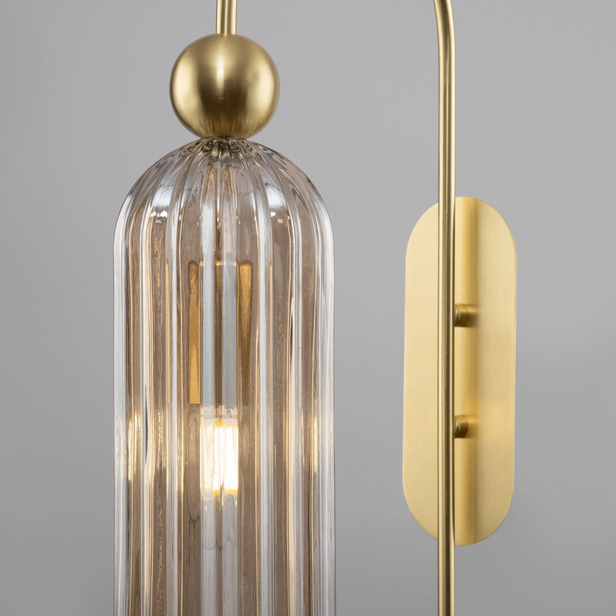 Close-up of the Antic wall light in gold with cognac glass, showcasing the warm tones and classic appeal.