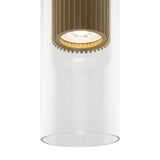 A close-up shot of the Dynamics Pendant Light - Gold With Outer Clear Glass, featuring a sleek cylindrical design with a ribbed gold-finish interior. The visible bulb emits a soft glow, embodying the elegance and minimalist charm of contemporary lighting.