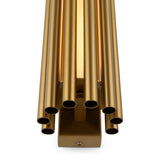 Close-up of the Sonata LED Wall Light in brass, showcasing its cylindrical design and energy-efficient glow. The shiny surface reflects light beautifully, creating a warm golden appearance reminiscent of an elegant wind chime.