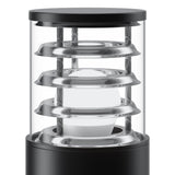 The Bronx Bollard Light 250mm - Black is ideal for garden paths, with a sleek cylindrical glass design, horizontal metal rings encircling the central bulb. The dark metallic base and top highlight modern outdoor lighting style.